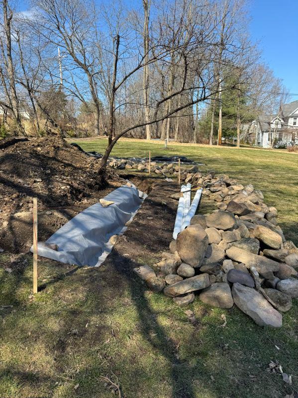 Stone drainage channel beside a lawn